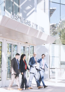 The Hone Law team exit Las Vegas City Hall walking dramatically