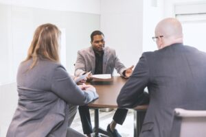 Hone Law attorneys discuss construction considerations in a bright conference room