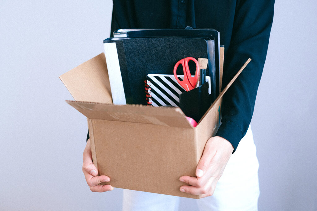 person carrying box of office supplies