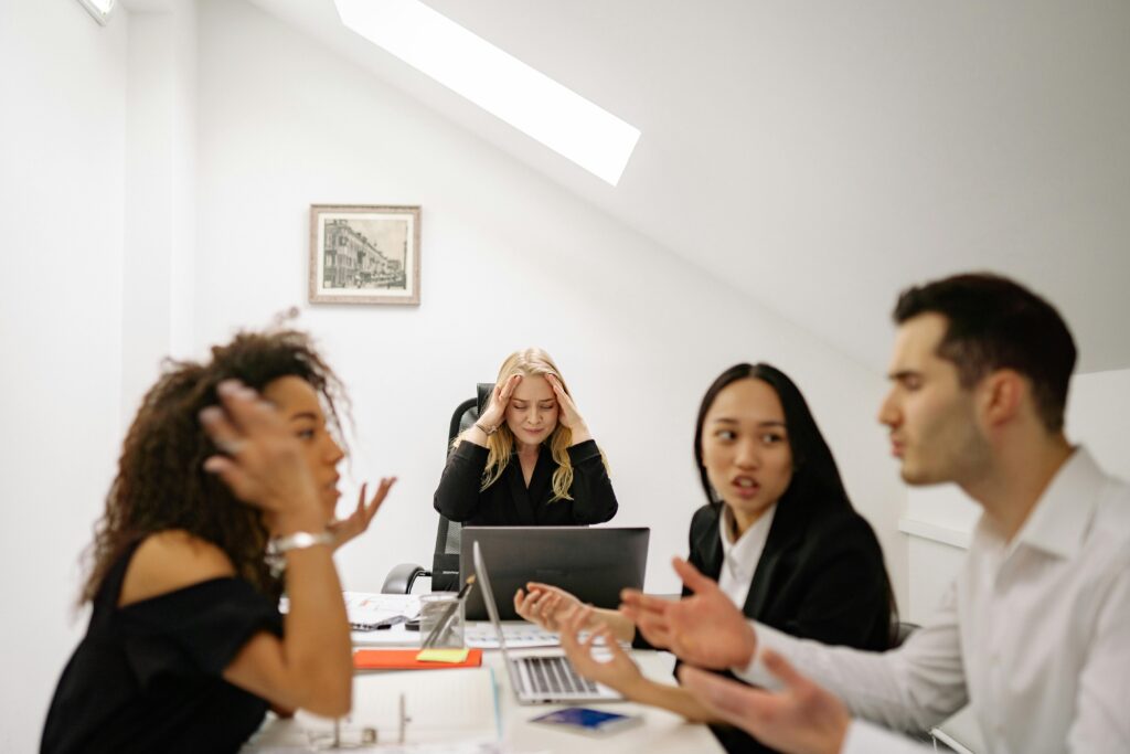 Four business owners arguing around a table